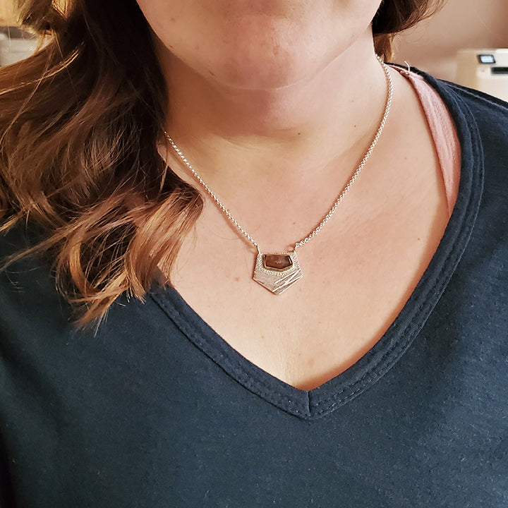 handmade silver pendant with speckled orange faceted gemstone choker