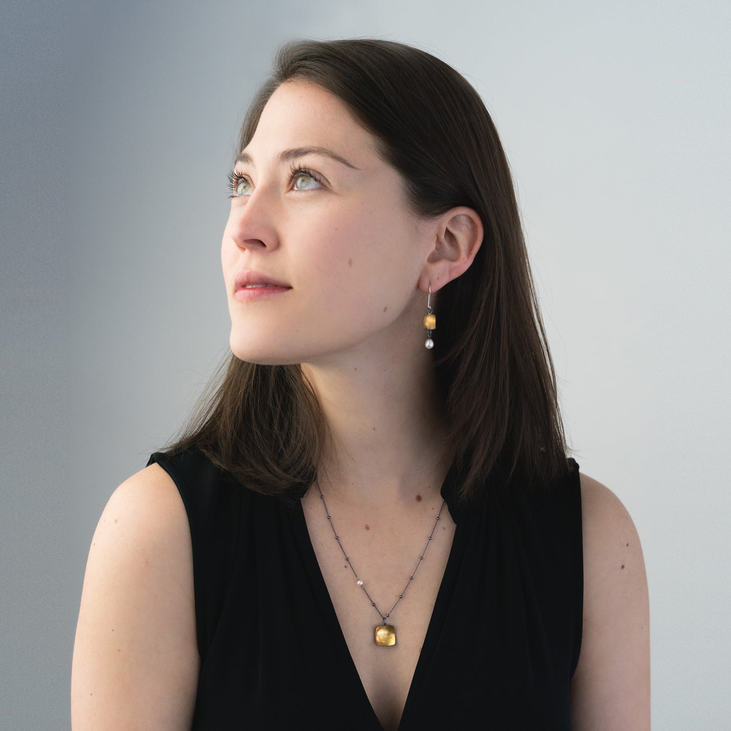 woman wearing oxidized silver and gold jewelry
