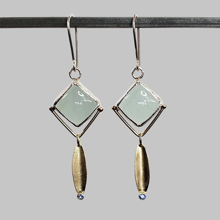 square blue stones set in silver with gold leaf dangles and bright blue gemstone accents