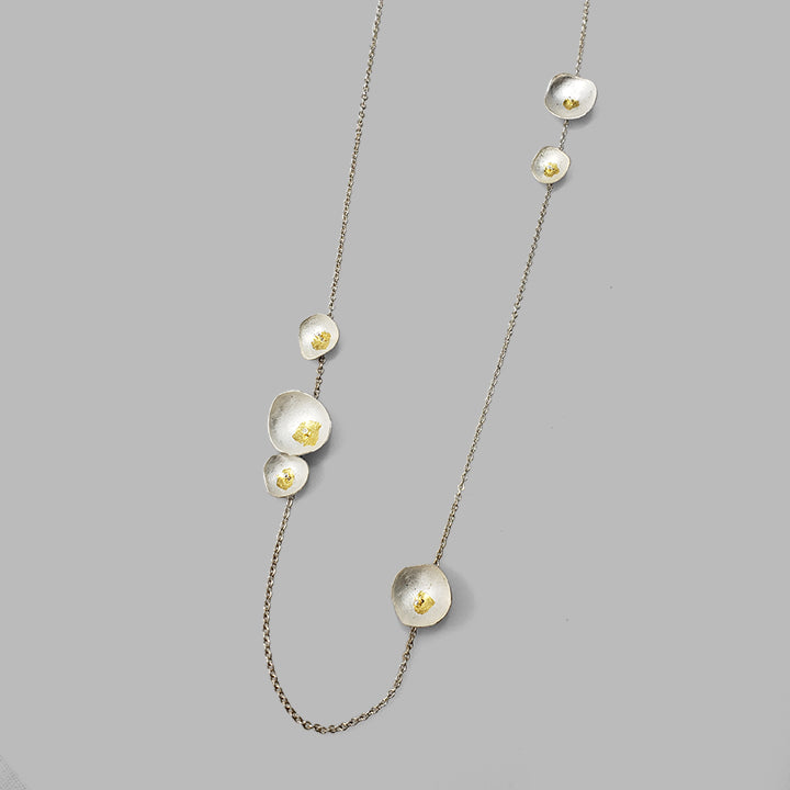 six silver cups on silver chain with gold details