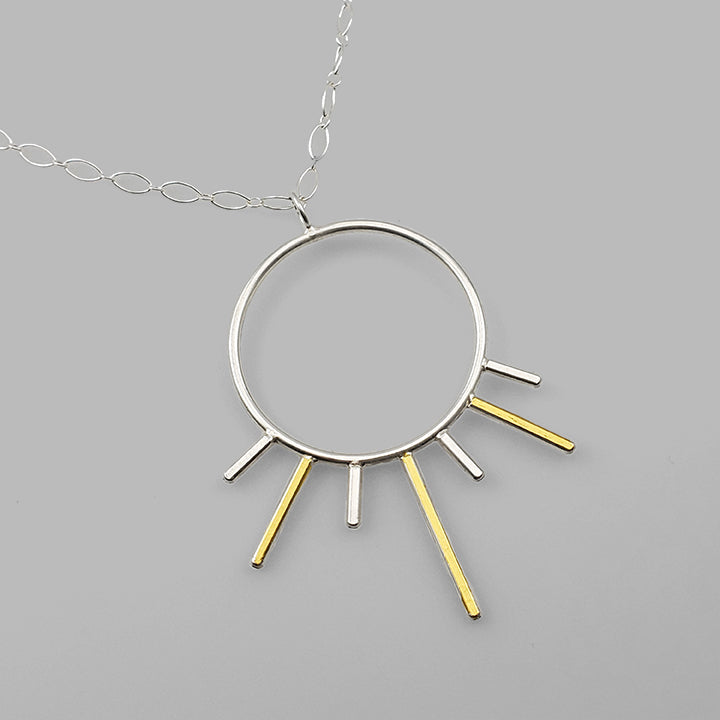 silver hoop pendant with gold and silver bars sun burst on chain
