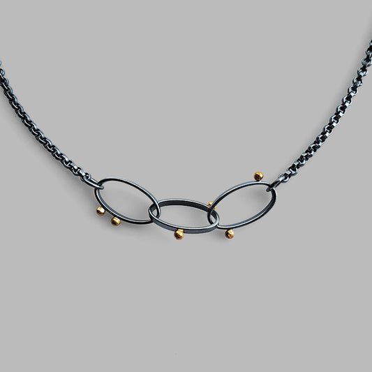 three oval hoops links on chain with scattered gold dots