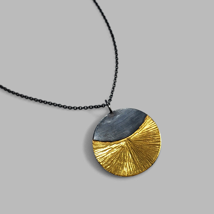 round oxidized silver and gold hammered pendant on chain