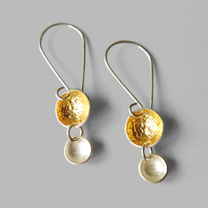 two silver graduated cups dangles large cup with hammered gold