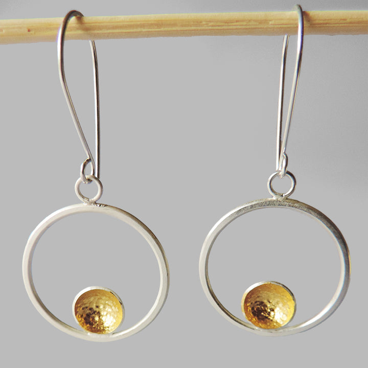 silver hoop dangles with one hammered cup gold inside