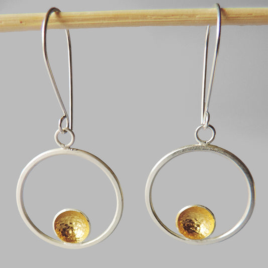 silver hoop dangles with one hammered cup gold inside