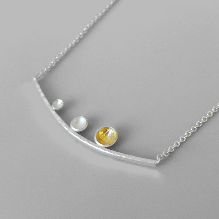 curved silver bar with 3 graduated cups one hammered with gold on chain