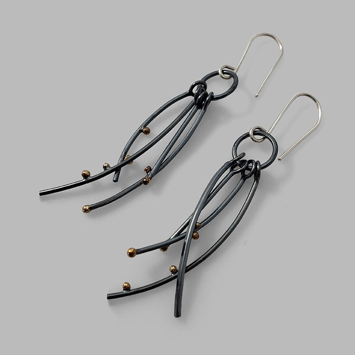 multiple oxidized silver curved wires with gold dots dangles