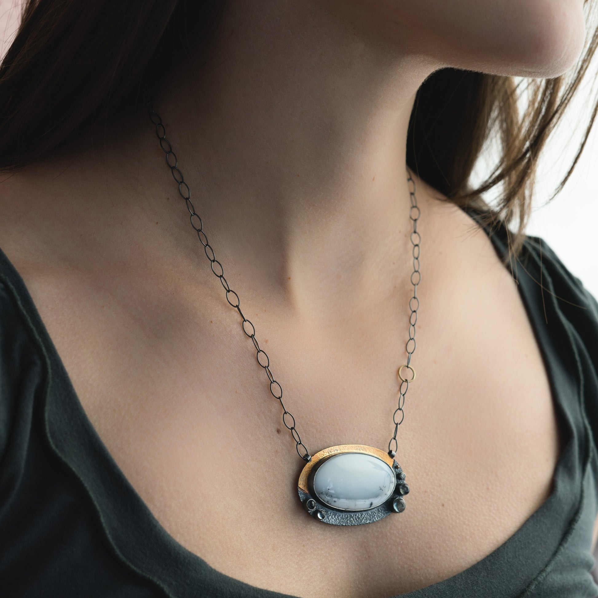 woman wearing white gemstone necklace