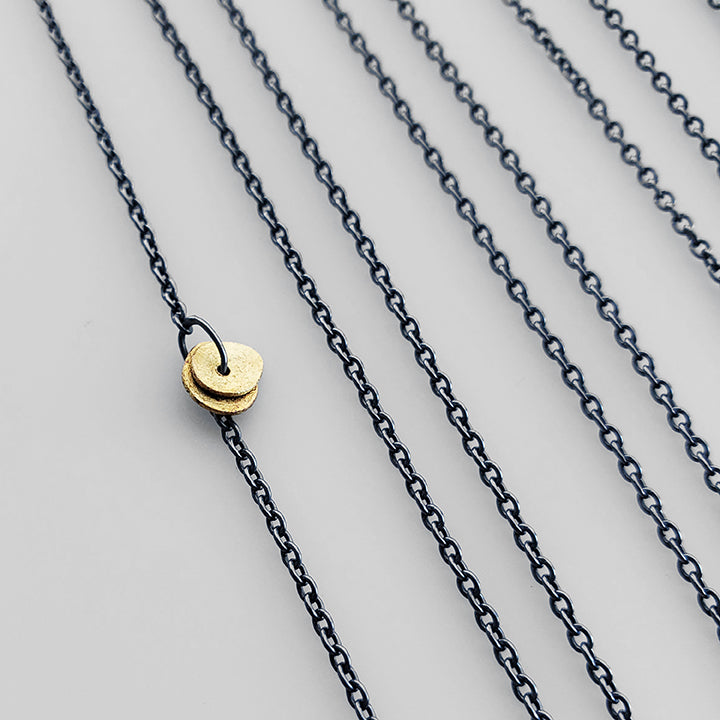 oxidized silver chain with flat gold bead