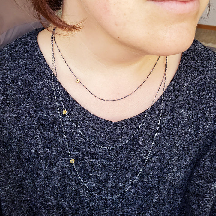 layered oxidized silver chains with gold organic charms