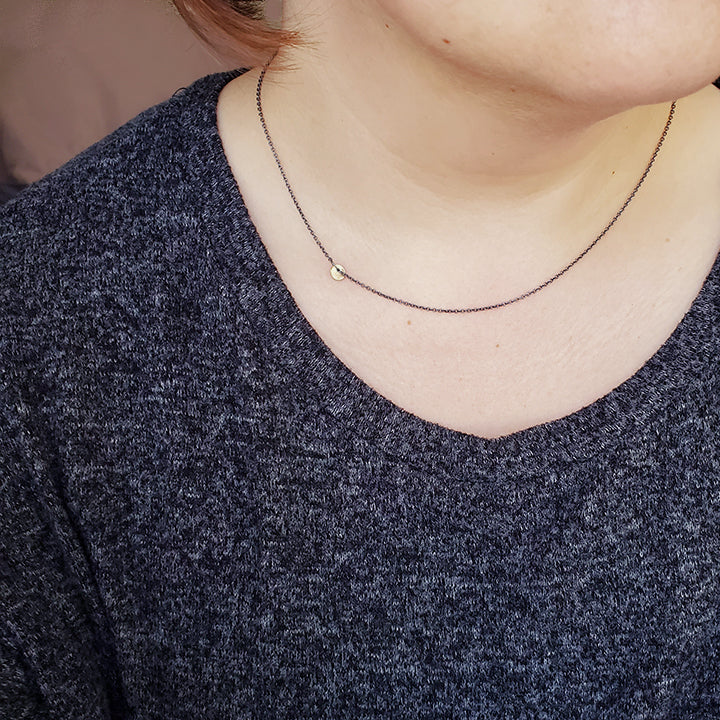 short oxidized silver chain with gold charm