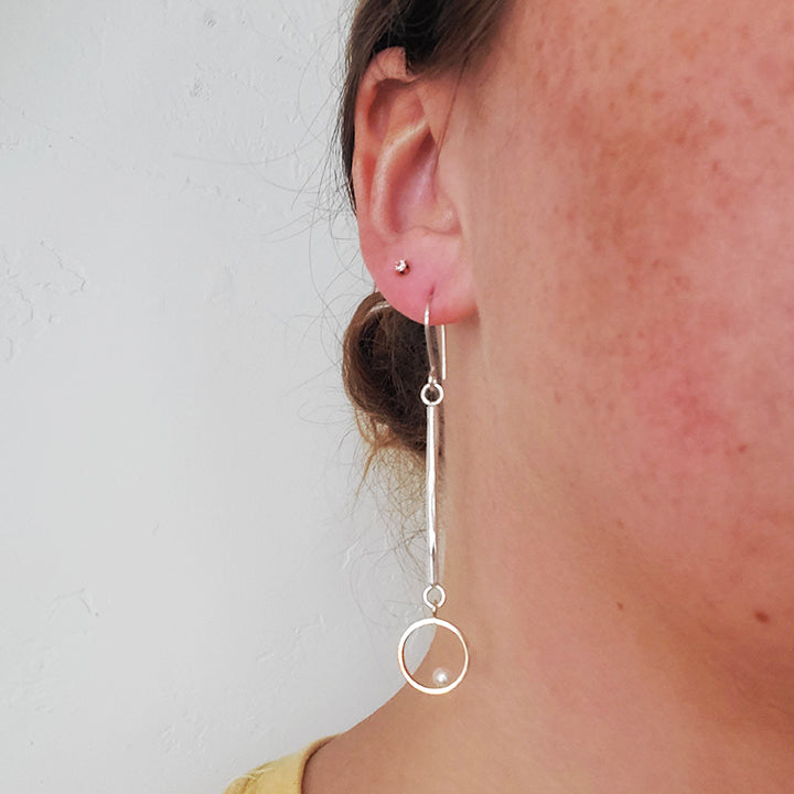 round gold hoop with pearl on silver bar earrings
