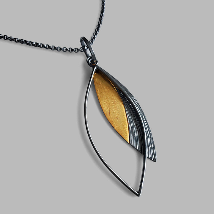 oxidized silver and gold textured leaf shaped pendant
