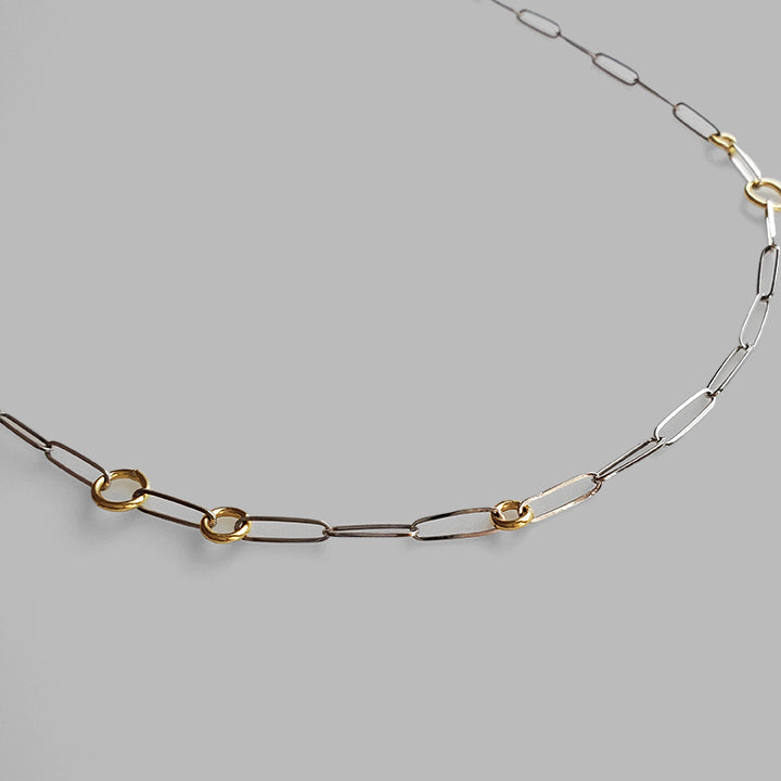 flat silver linked chain with round gold hoops necklace