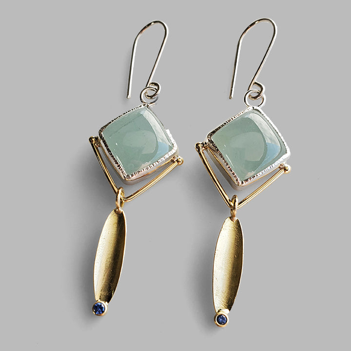 square blue stones set in silver with gold leaf dangles and bright blue gemstone accents