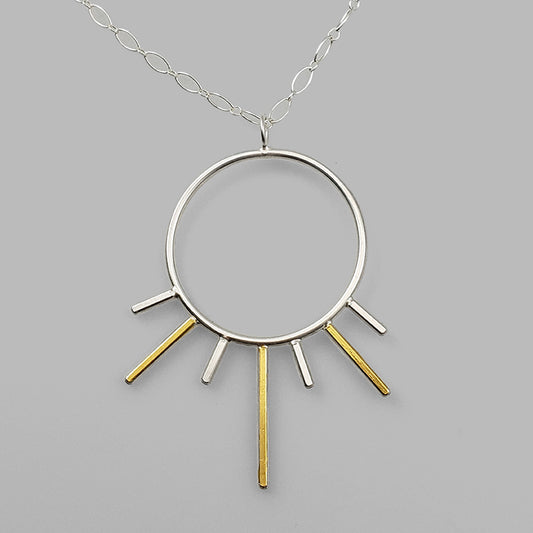 silver hoop pendant with gold and silver bars sun burst on chain