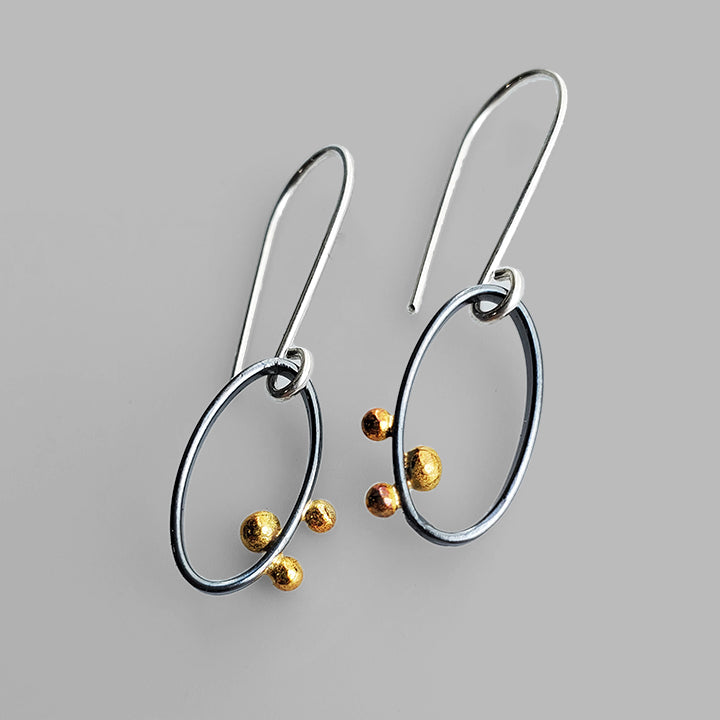 oval oxidized silver small silver hoops with three gold dots
