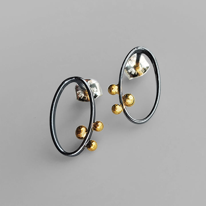 oval hoop posts oxidized silver with 3 gold dots