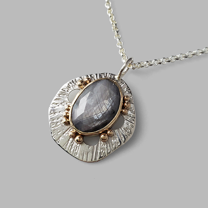 grey sapphire set in gold on silver textured pendant with gold dots