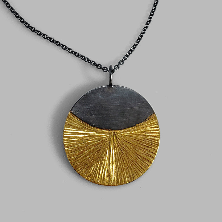 round oxidized silver and gold hammered pendant on chain