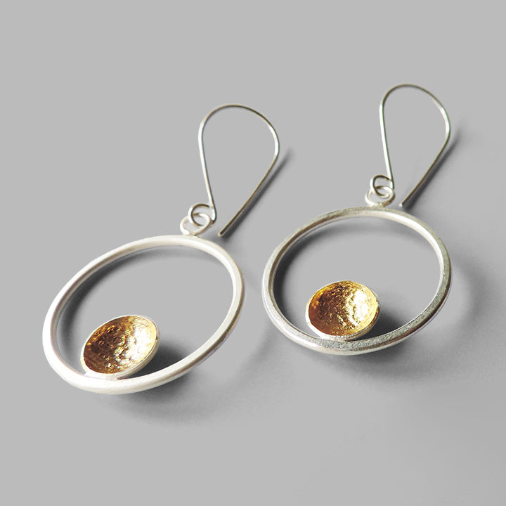silver hoop dangles with one hammered cup gold inside