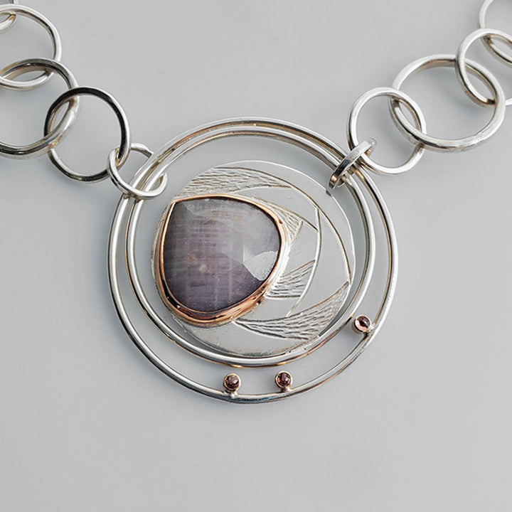large silver textured round pendant with teardrop rose cut pink gemstone set in rose gold