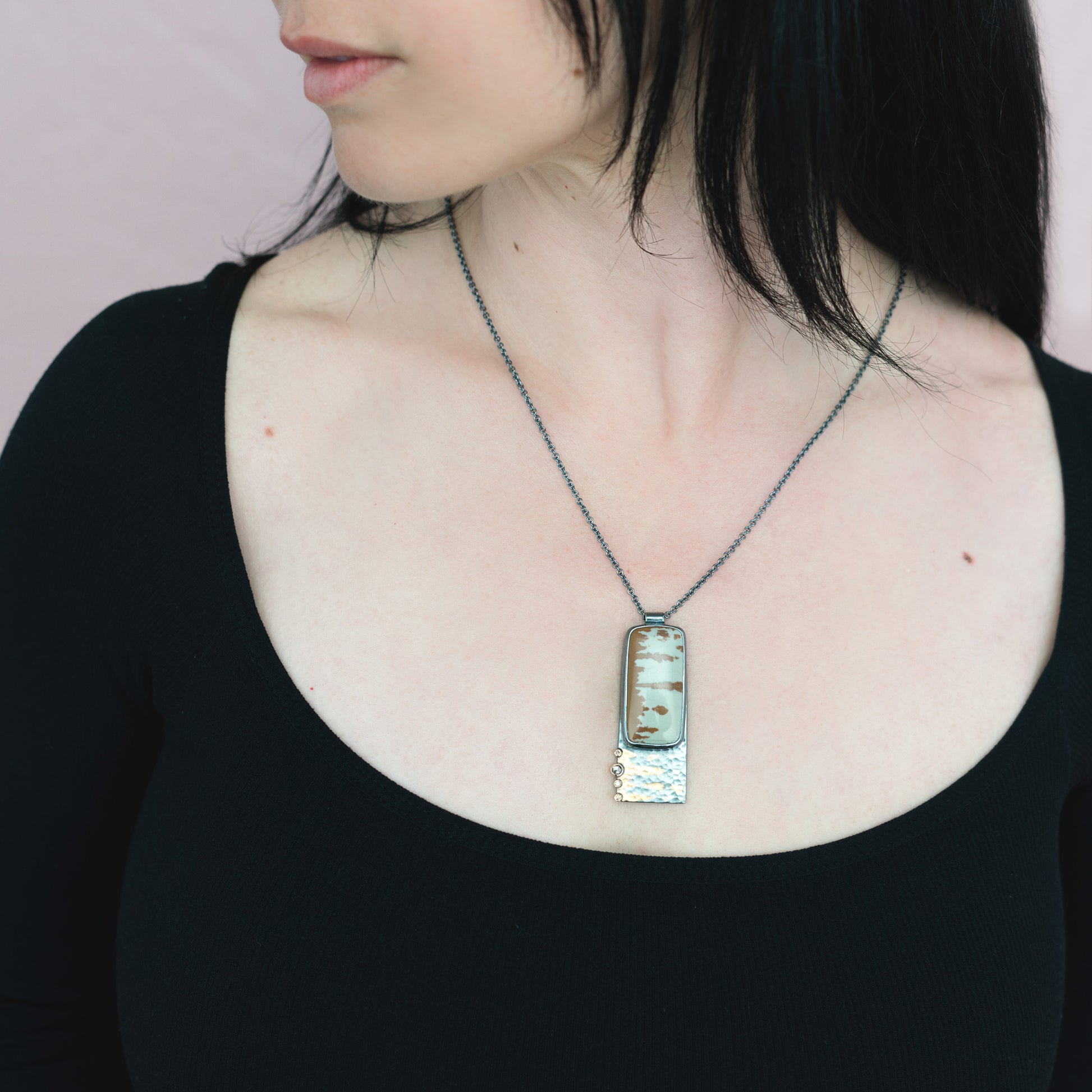 woman wearing rectangle mixed metal necklace
