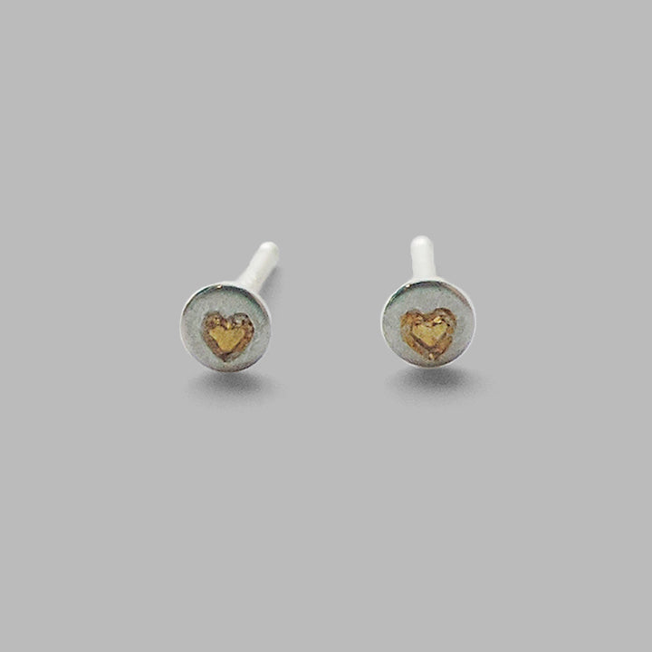 small silver circle posts with gold heart