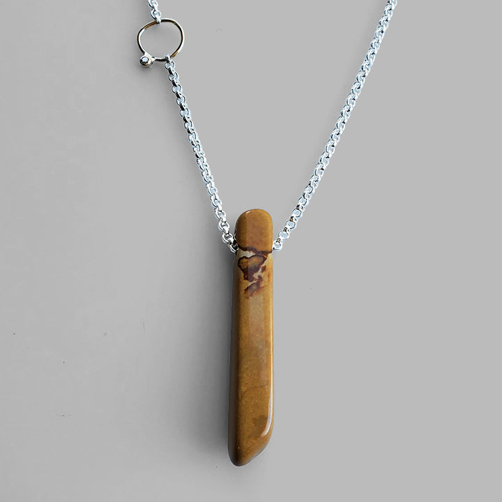brown stick shaped stone on silver chain with champagne diamond on gold hoop