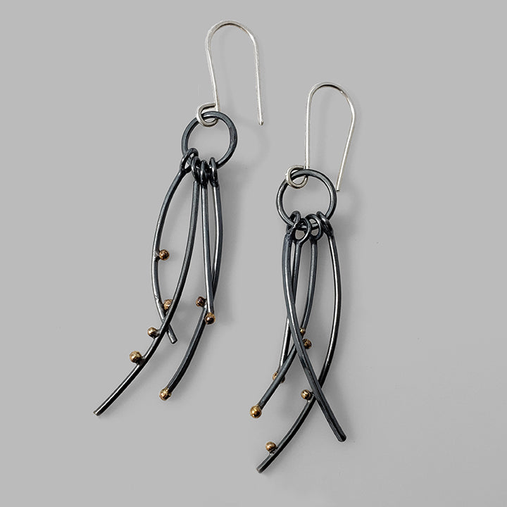 multiple oxidized silver curved wires with gold dots dangles