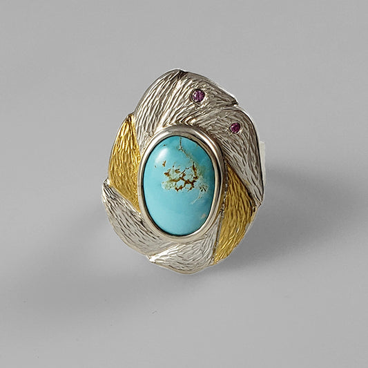 mixed metal silver and gold textured ring with pink gemstones and teal center stone in silver