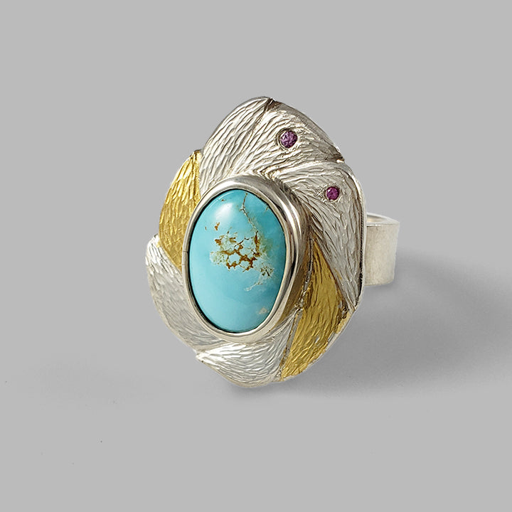 mixed metal silver and gold textured ring with pink gemstones and teal center stone