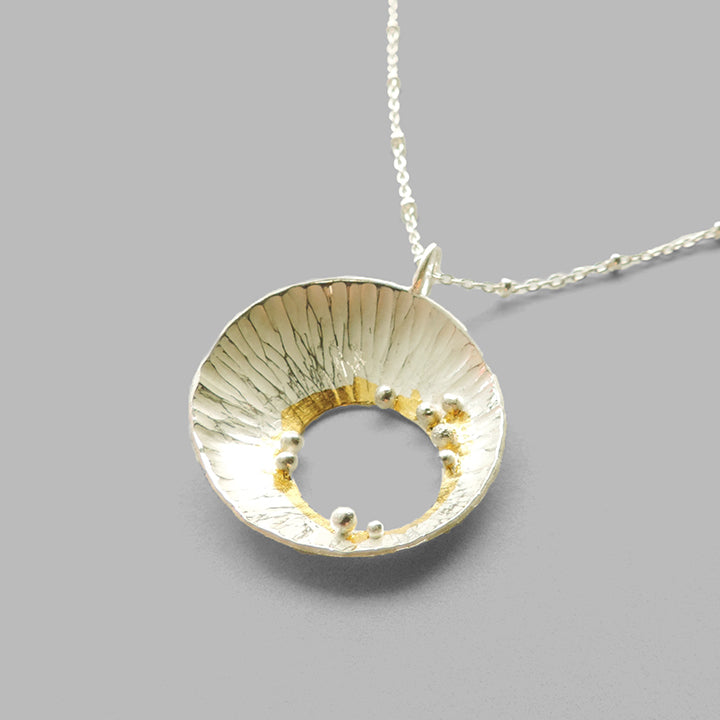 hammered silver cup pendant with silver dots and gold accents