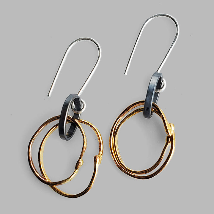 nature inspired organic gold hoops on oxidized oval silver hoops dangles