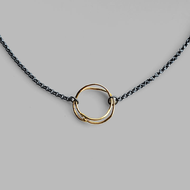 round organic gold hoops on oxidized silver chain