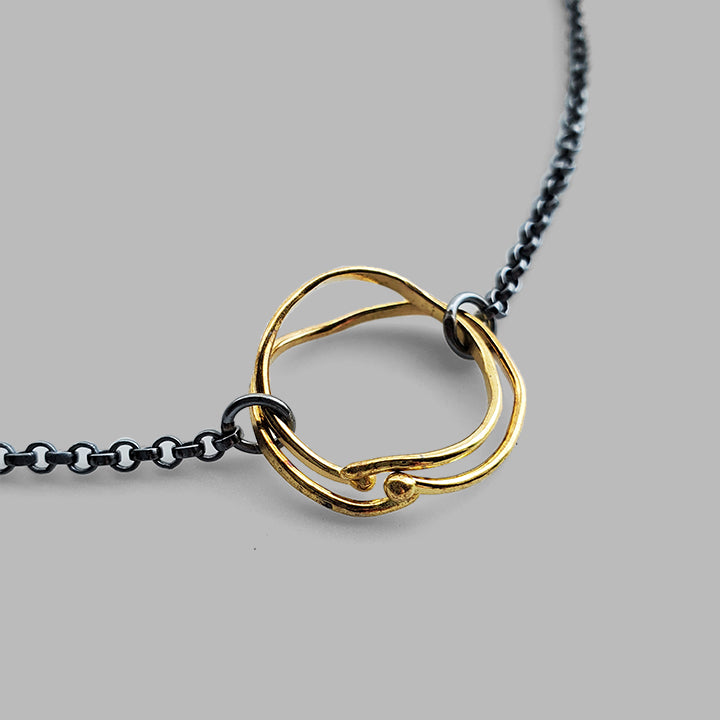 nature inspired round gold hoops on oxidized silver chain