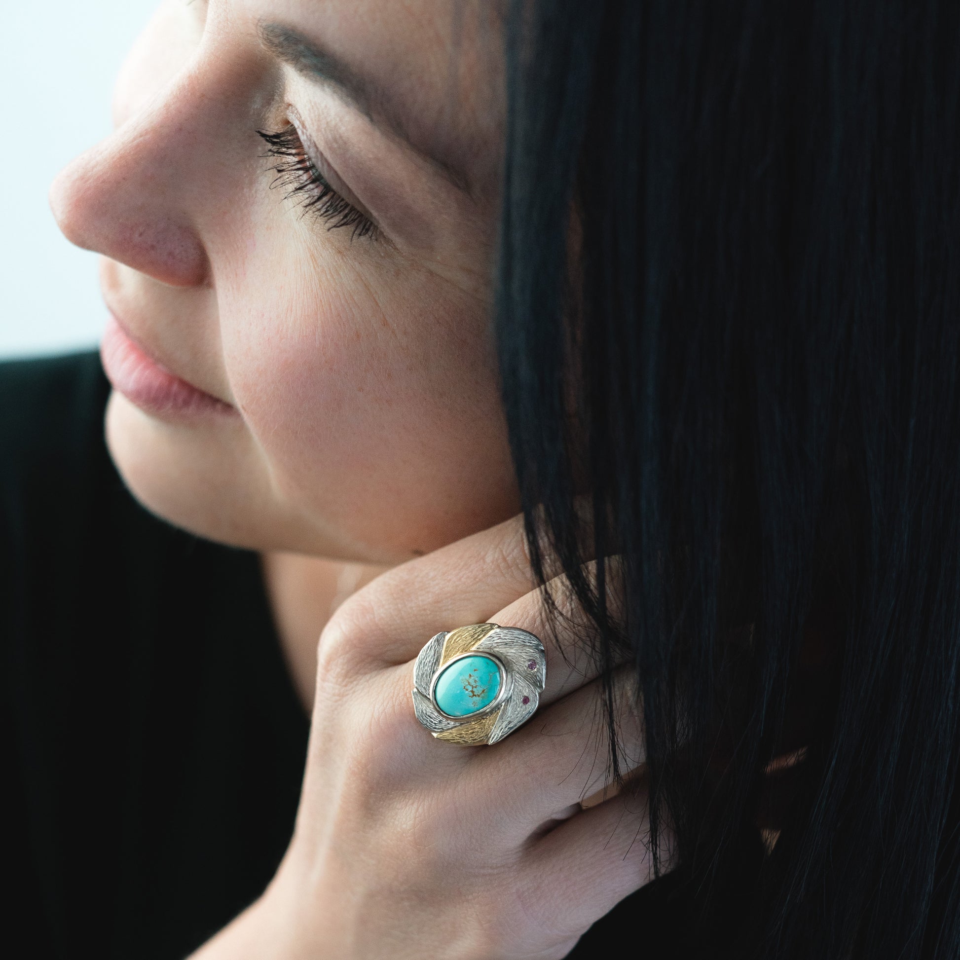 woman wearing teal stone ring